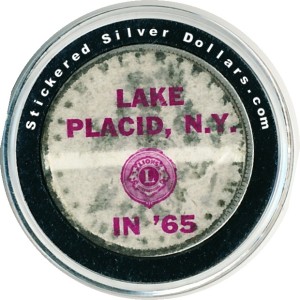 Sticker put on a Morgan silver dollar by the Lion's Club of Lake Placid, N.Y in 1965.