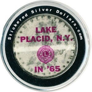 Sticker put on a Morgan silver dollar by the Lion's Club of Lake Placid, N.Y in 1965. 